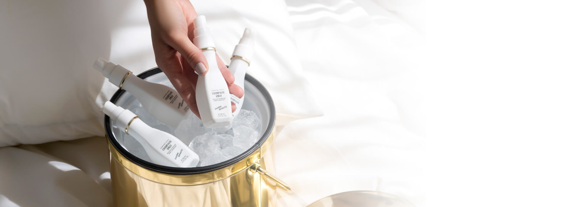 Champagne bucket filled with Cuvee Beauty's Champagne Spray in Travel size